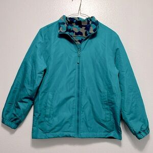 Reversible jacket, fuzzy side and windbreaker side. Good condition, pockets